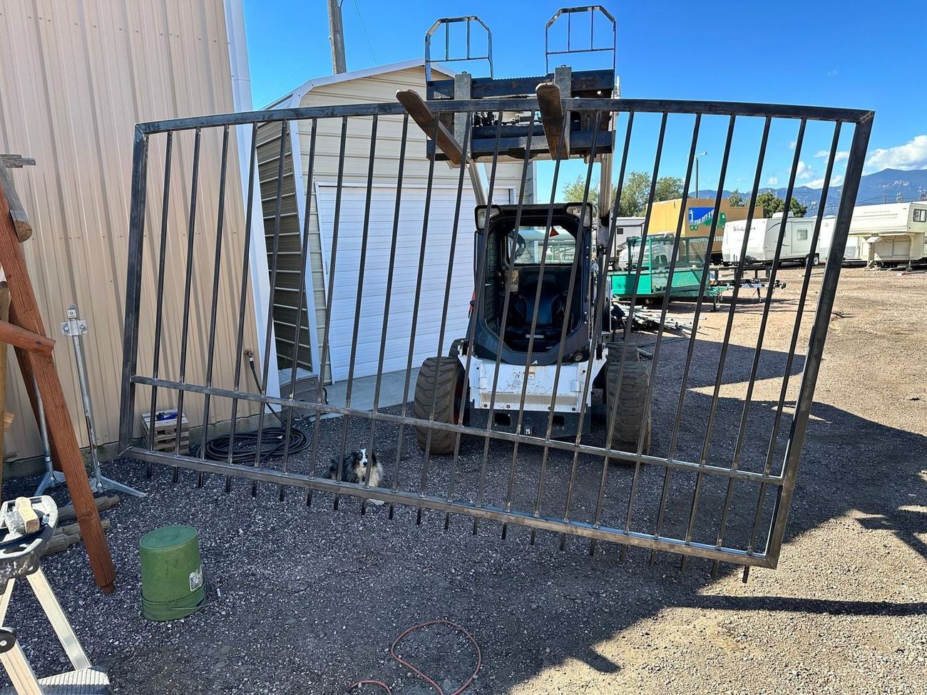Large custom fabricated iron ranch driveway gate in the Alpine Fence yard